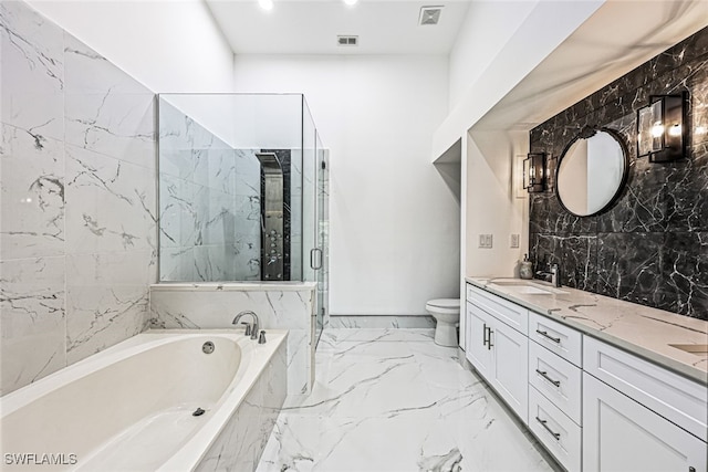 full bathroom with vanity, separate shower and tub, and toilet