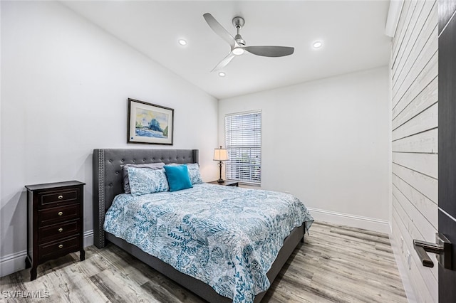 bedroom with lofted ceiling, light hardwood / wood-style floors, and ceiling fan