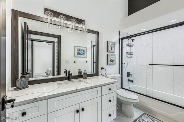 full bathroom with shower / bath combination with glass door, toilet, vanity, and tile patterned floors