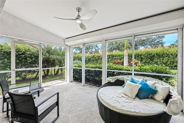 sunroom / solarium featuring vaulted ceiling, ceiling fan, and a healthy amount of sunlight