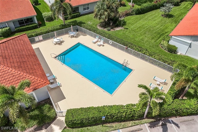 view of swimming pool featuring a yard and a patio