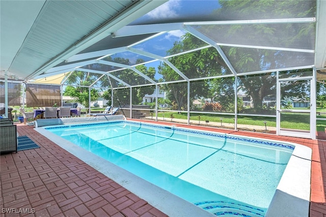 view of swimming pool with a lanai and a patio area