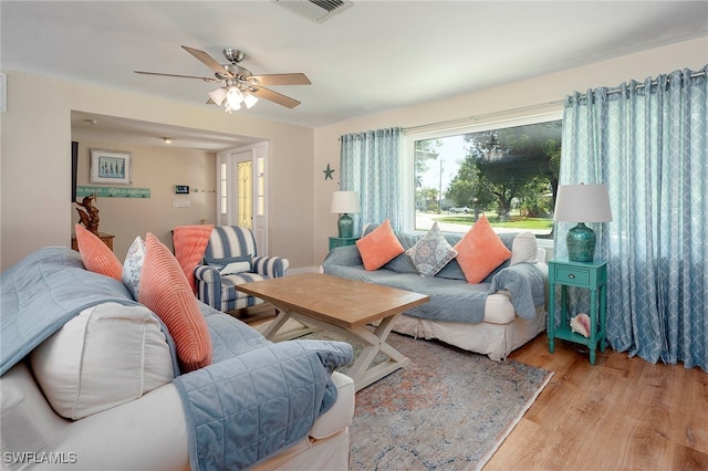 living room featuring light wood-type flooring and ceiling fan