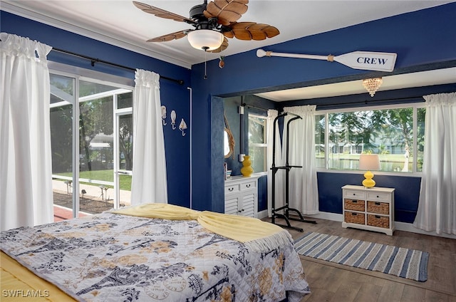 bedroom featuring access to outside, wood-type flooring, multiple windows, and ceiling fan