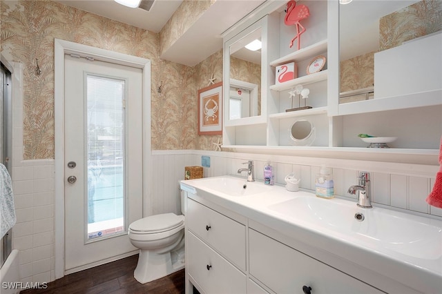 bathroom with wood-type flooring, vanity, and toilet