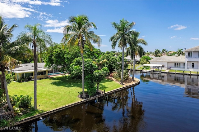 exterior space featuring a lawn and a water view