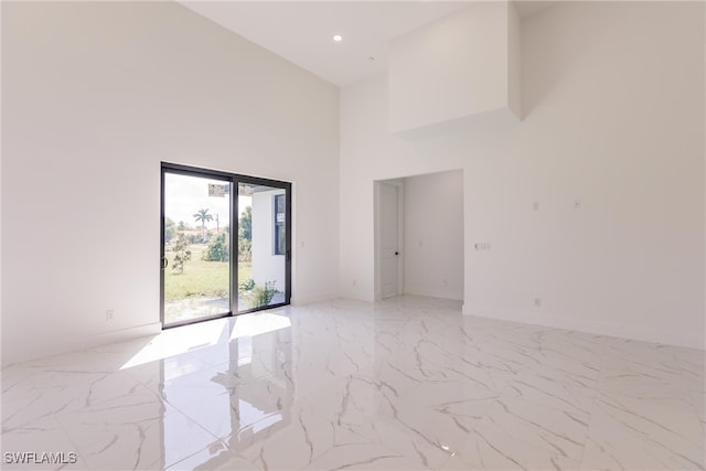 unfurnished room with a towering ceiling