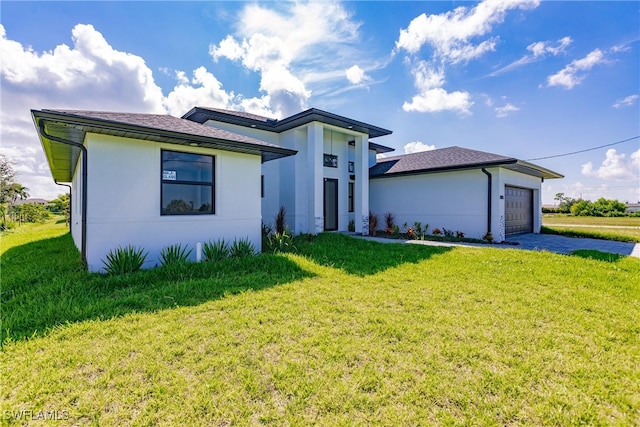 view of front of property with a garage and a front yard