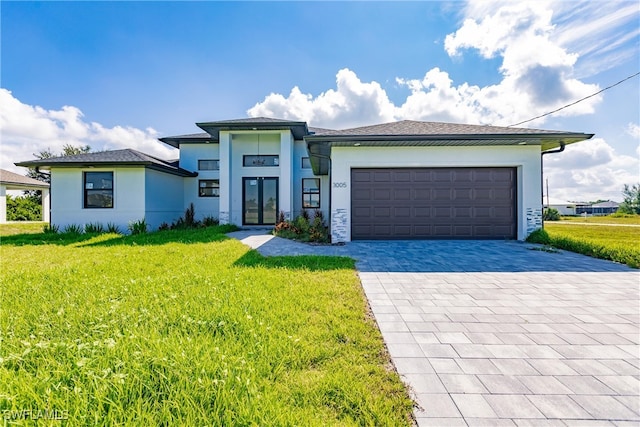 prairie-style home with a front yard and a garage