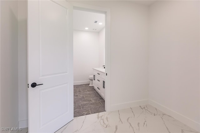 bathroom featuring vanity and toilet