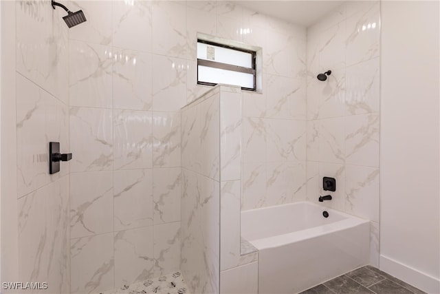 bathroom with tile patterned flooring and tiled shower / bath