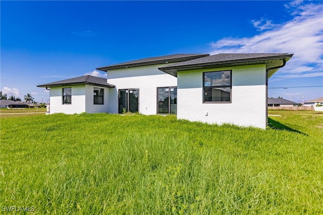 rear view of house with a yard