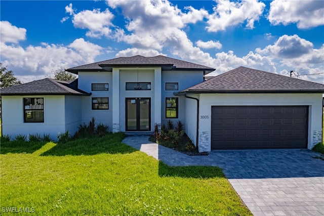 view of front of house with a front yard and a garage