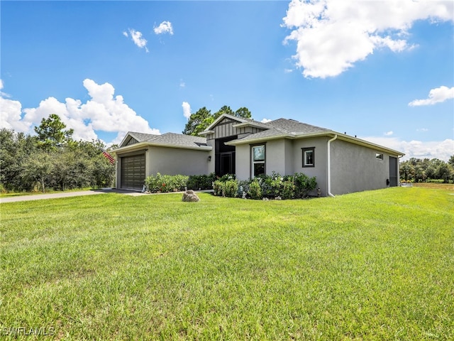 view of front of property with a garage and a front lawn