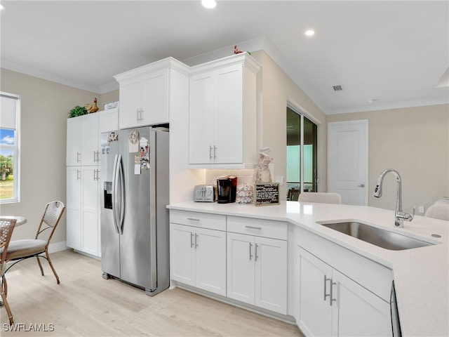 kitchen featuring white cabinets, crown molding, light hardwood / wood-style flooring, sink, and stainless steel fridge with ice dispenser