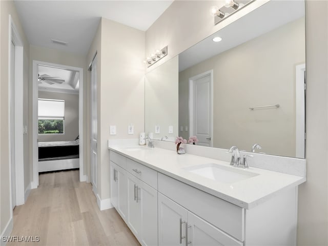 bathroom featuring ceiling fan, vanity, and hardwood / wood-style flooring