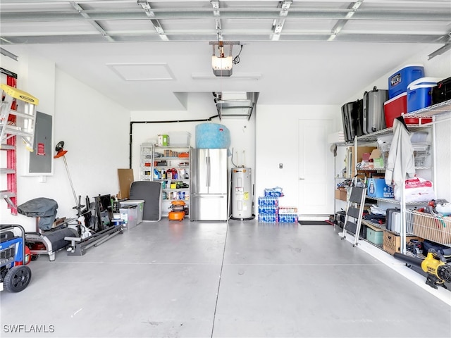 garage featuring a garage door opener, electric panel, stainless steel fridge, and electric water heater