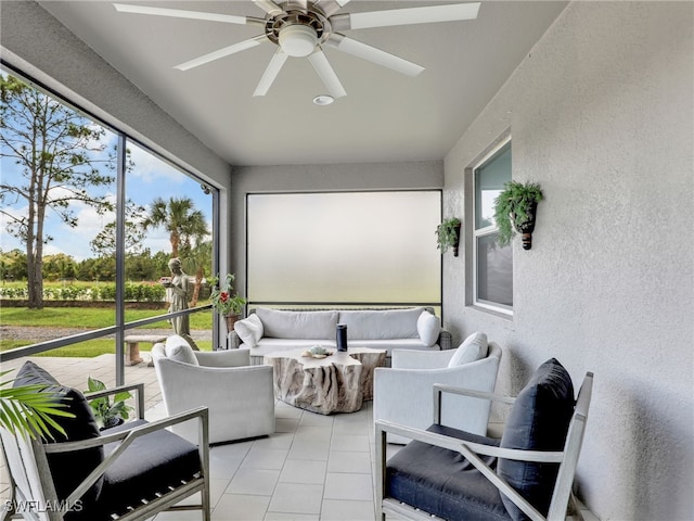 sunroom featuring ceiling fan