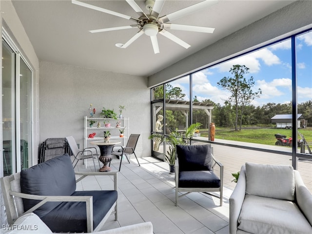 sunroom featuring ceiling fan