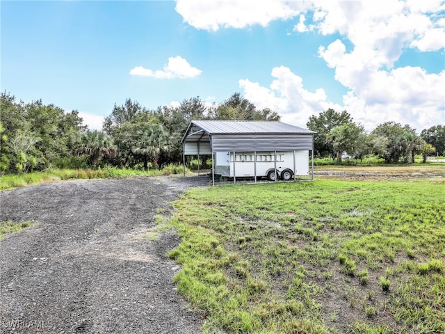 exterior space with a front yard and a carport