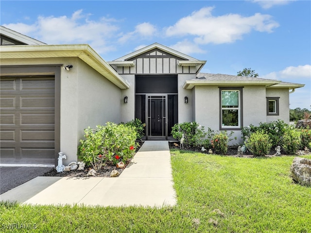 property entrance featuring a garage and a yard