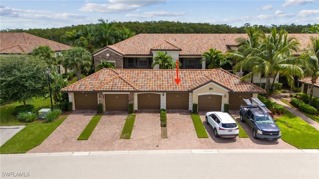 mediterranean / spanish-style home featuring a garage