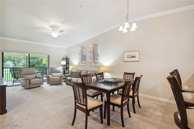 dining space featuring ceiling fan with notable chandelier, crown molding, and light colored carpet