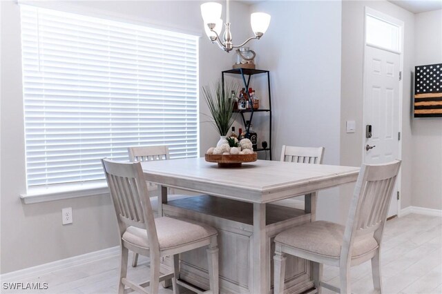 dining room featuring a chandelier and light hardwood / wood-style floors