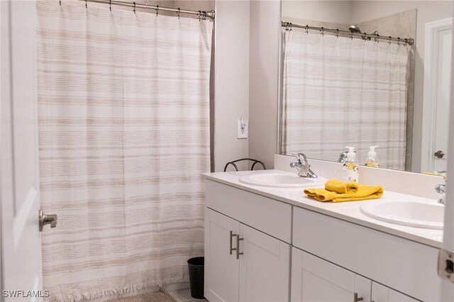 bathroom with walk in shower and vanity