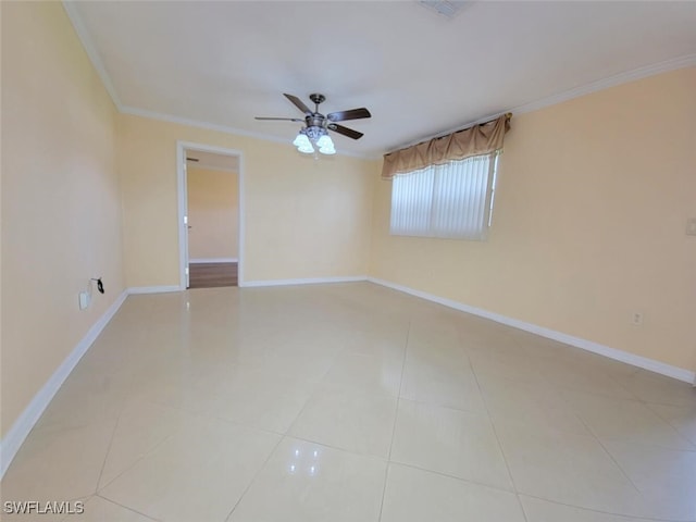 tiled empty room with ceiling fan and crown molding