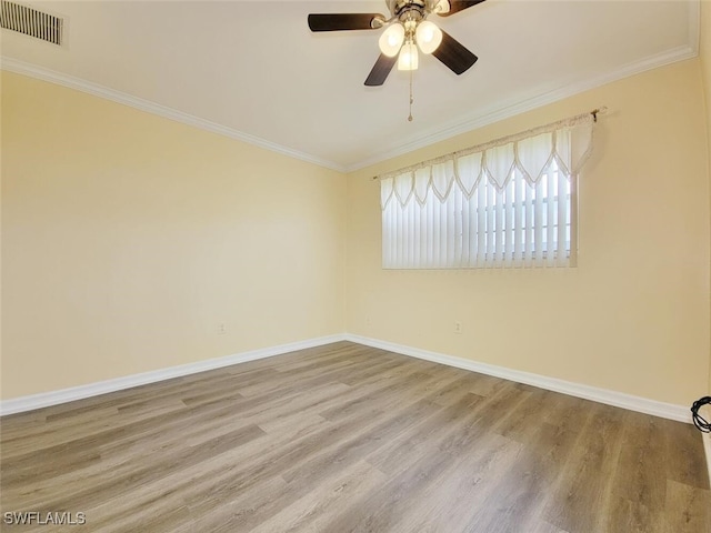 empty room featuring hardwood / wood-style floors, ceiling fan, and crown molding