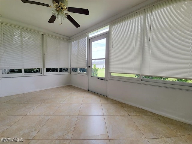 unfurnished sunroom with ceiling fan