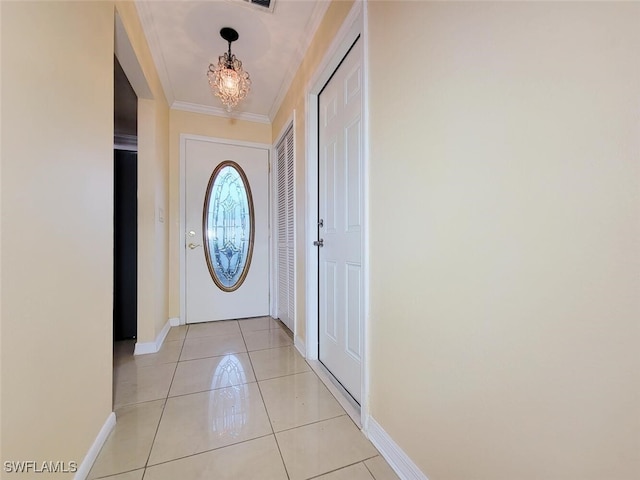 doorway featuring crown molding, light tile patterned floors, and an inviting chandelier