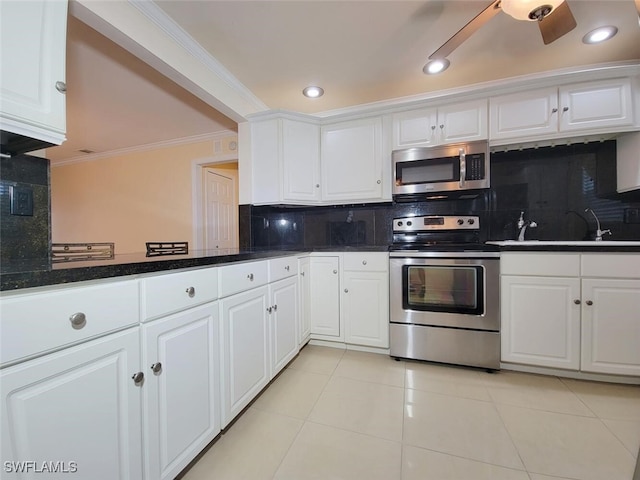 kitchen with decorative backsplash, white cabinetry, and stainless steel appliances