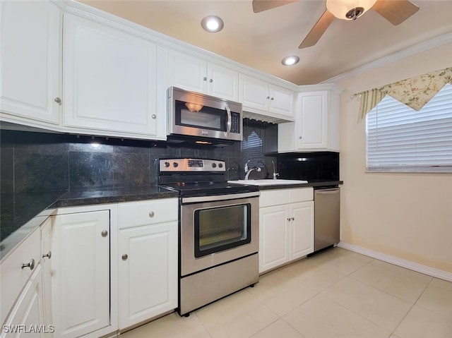 kitchen featuring white cabinetry, sink, tasteful backsplash, appliances with stainless steel finishes, and ornamental molding