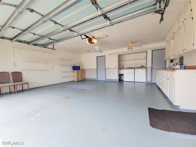 garage featuring independent washer and dryer, a garage door opener, and ceiling fan