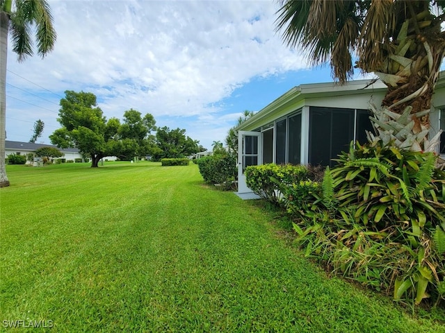 view of yard featuring a sunroom