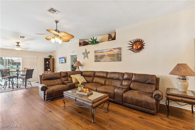 living room with ceiling fan, vaulted ceiling, and hardwood / wood-style floors