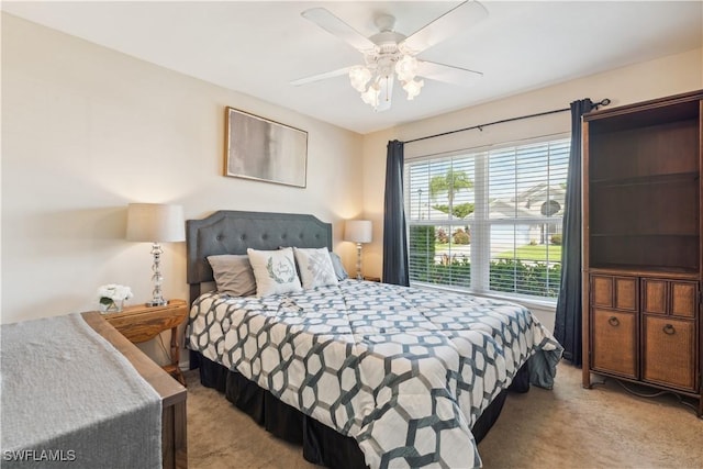 bedroom featuring light carpet and ceiling fan
