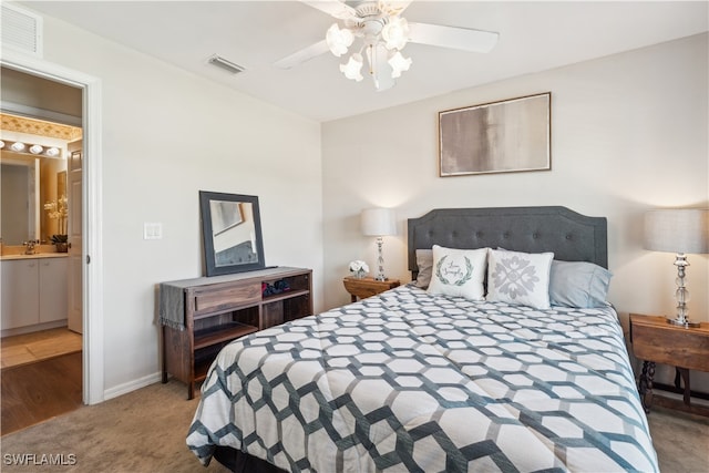 bedroom featuring ceiling fan, sink, connected bathroom, and carpet flooring