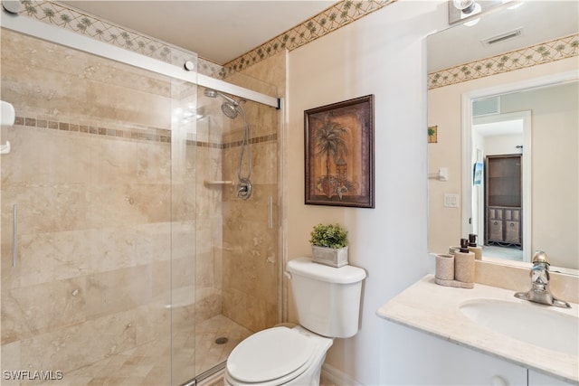 bathroom with walk in shower, vanity, and toilet