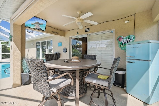 exterior space with a lanai, a ceiling fan, and outdoor dining area