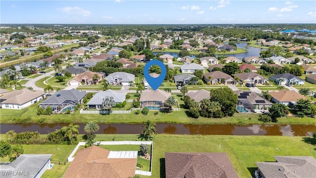 bird's eye view featuring a water view and a residential view