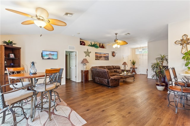 living room with lofted ceiling, hardwood / wood-style floors, and ceiling fan