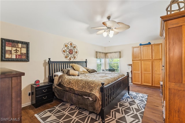 bedroom featuring ceiling fan and dark hardwood / wood-style floors