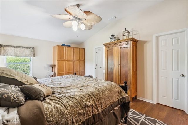 bedroom with ceiling fan, visible vents, baseboards, lofted ceiling, and dark wood finished floors