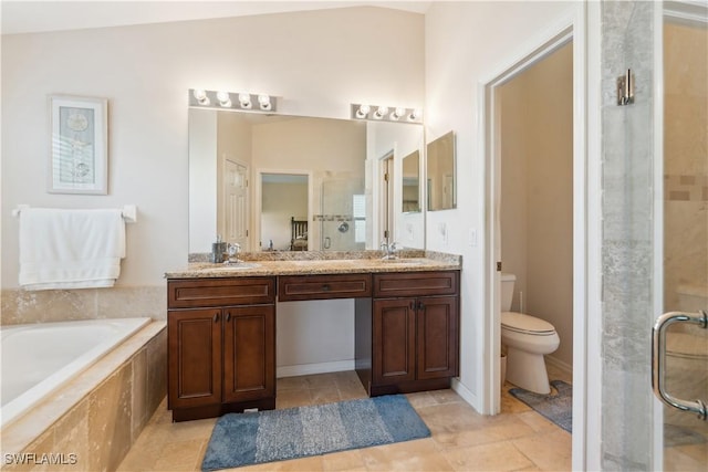 full bathroom featuring double vanity, a bath, a stall shower, and a sink