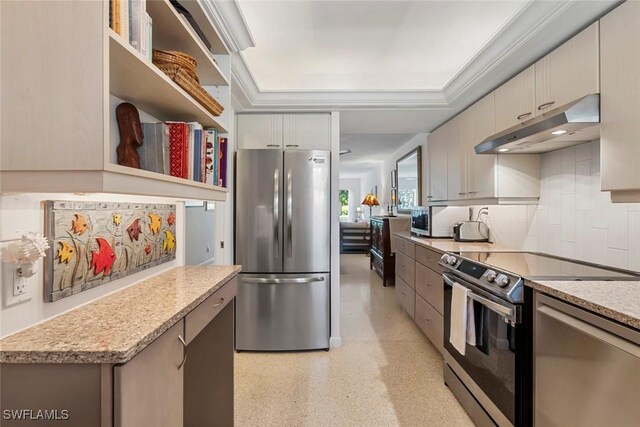 kitchen with light stone countertops, stainless steel appliances, tasteful backsplash, and crown molding