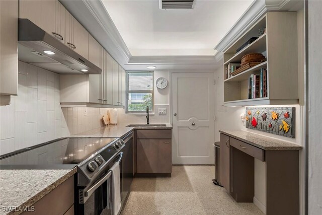 kitchen with tasteful backsplash, a raised ceiling, light stone countertops, sink, and electric range