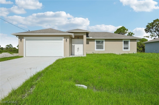 view of front of house with a front yard and a garage